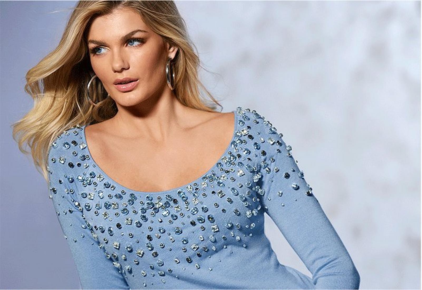 model wearing a light blue jewel embellished scoop neck sweater.