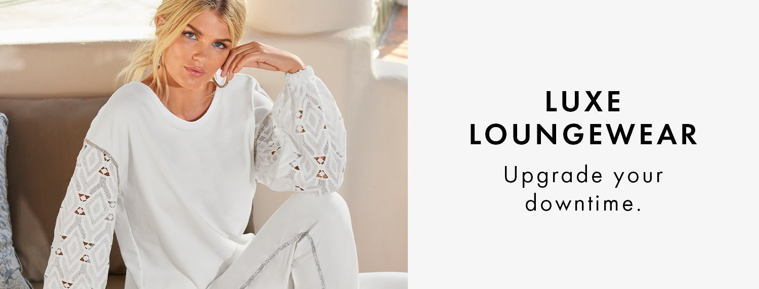 The Luxe Loungewear Collection model wearing a white lace lounge set.