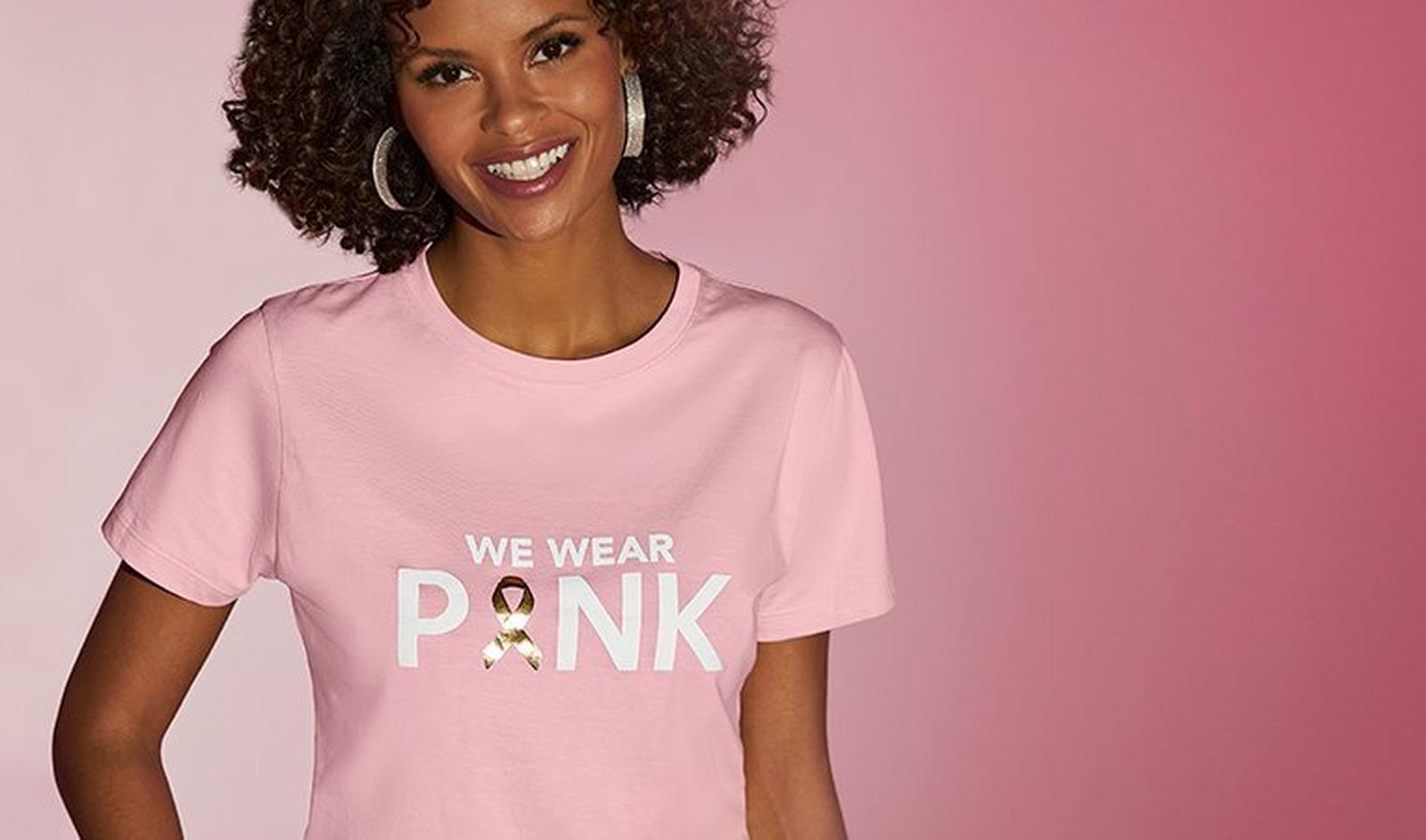 model wearing a pink breast cancer awareness themed shirt that says 