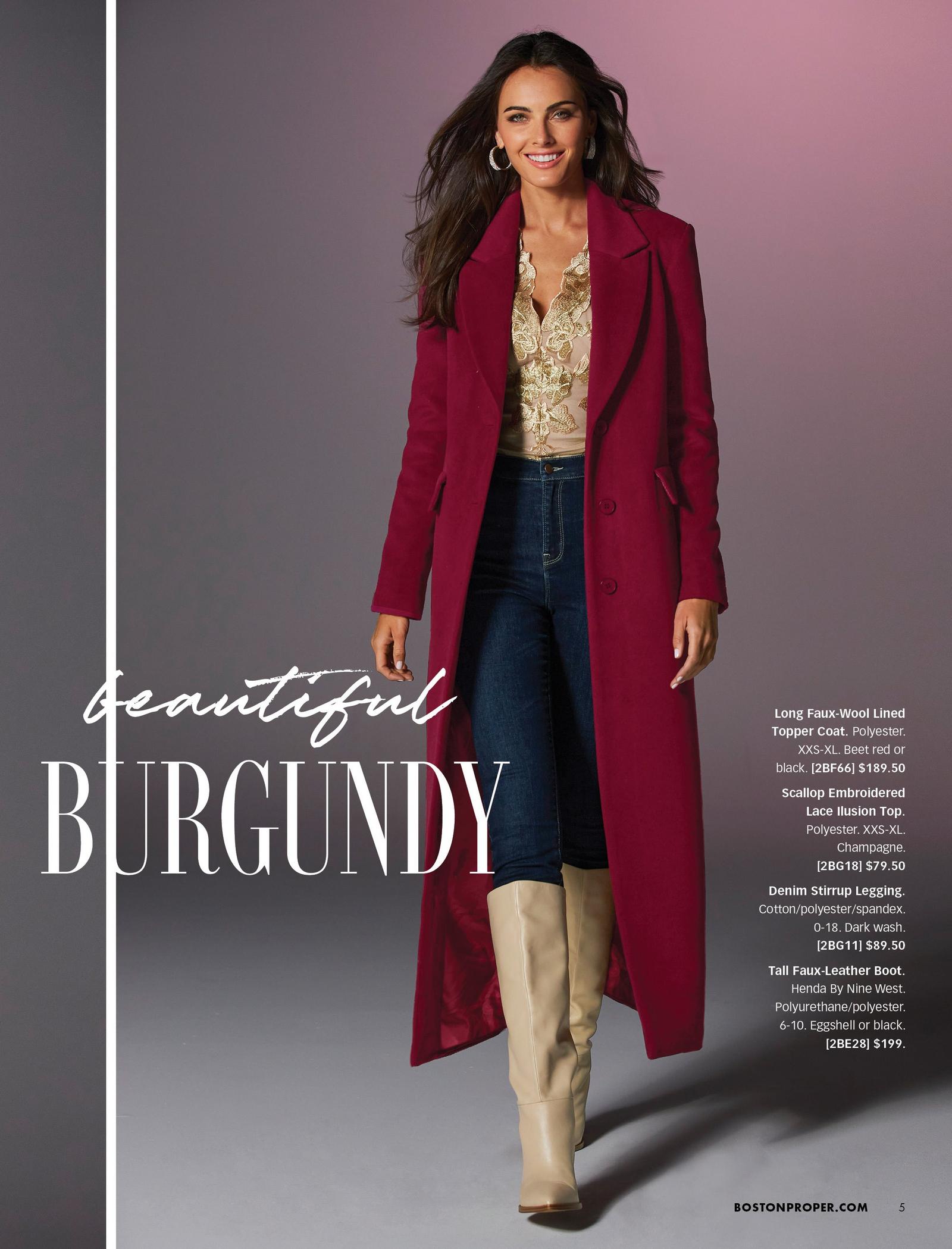 model wearing a burgundy faux-wool long coat, gold lace embroidered top, denim leggings, and tan faux-leather boots.