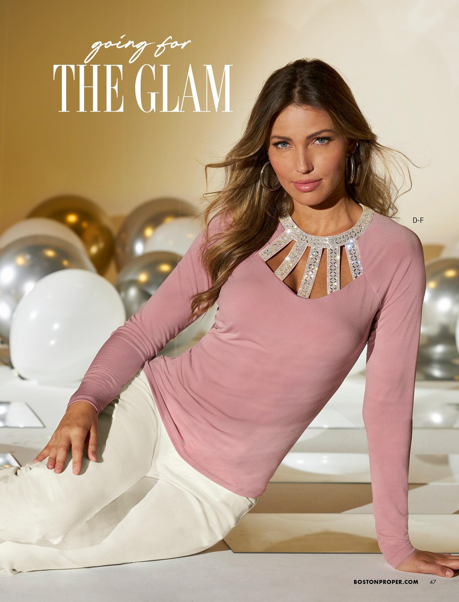 model wearing a light pink rhinestone embellished cage-detail long-sleeve top and white pants.