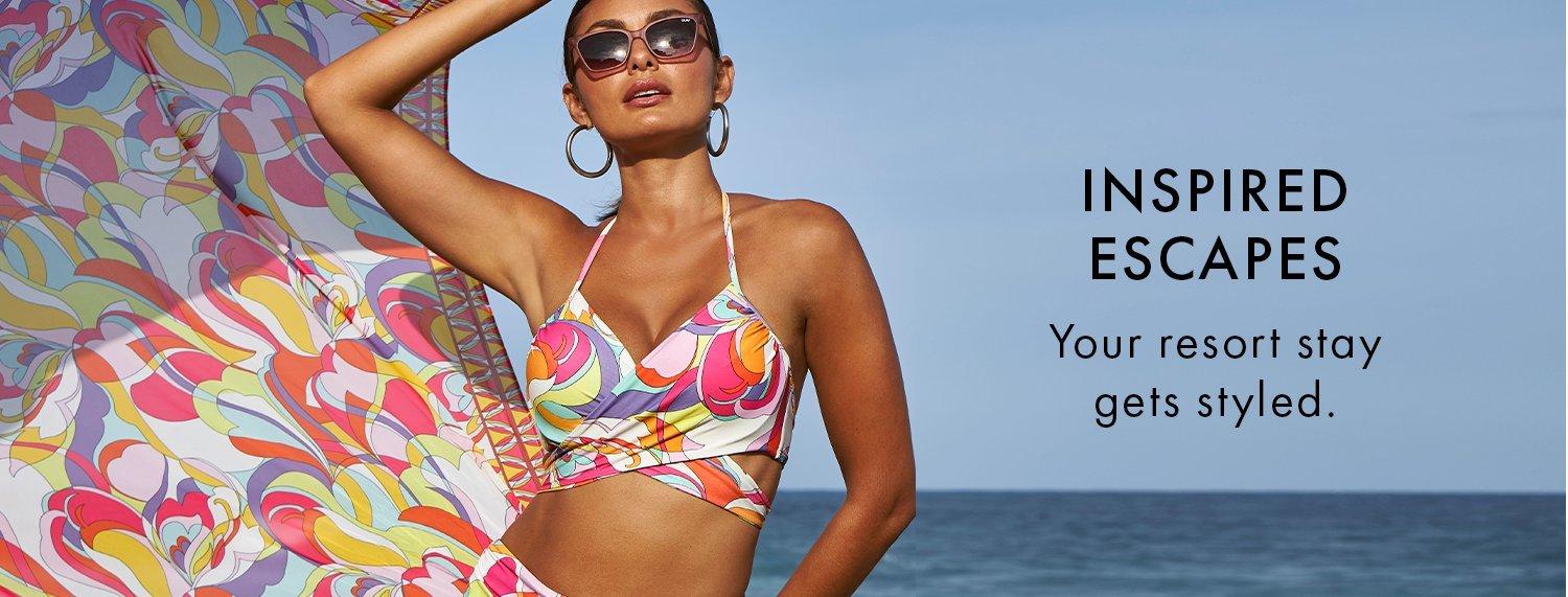model wearing a printed multicolored bikini, matching sarong, and sunglasses.