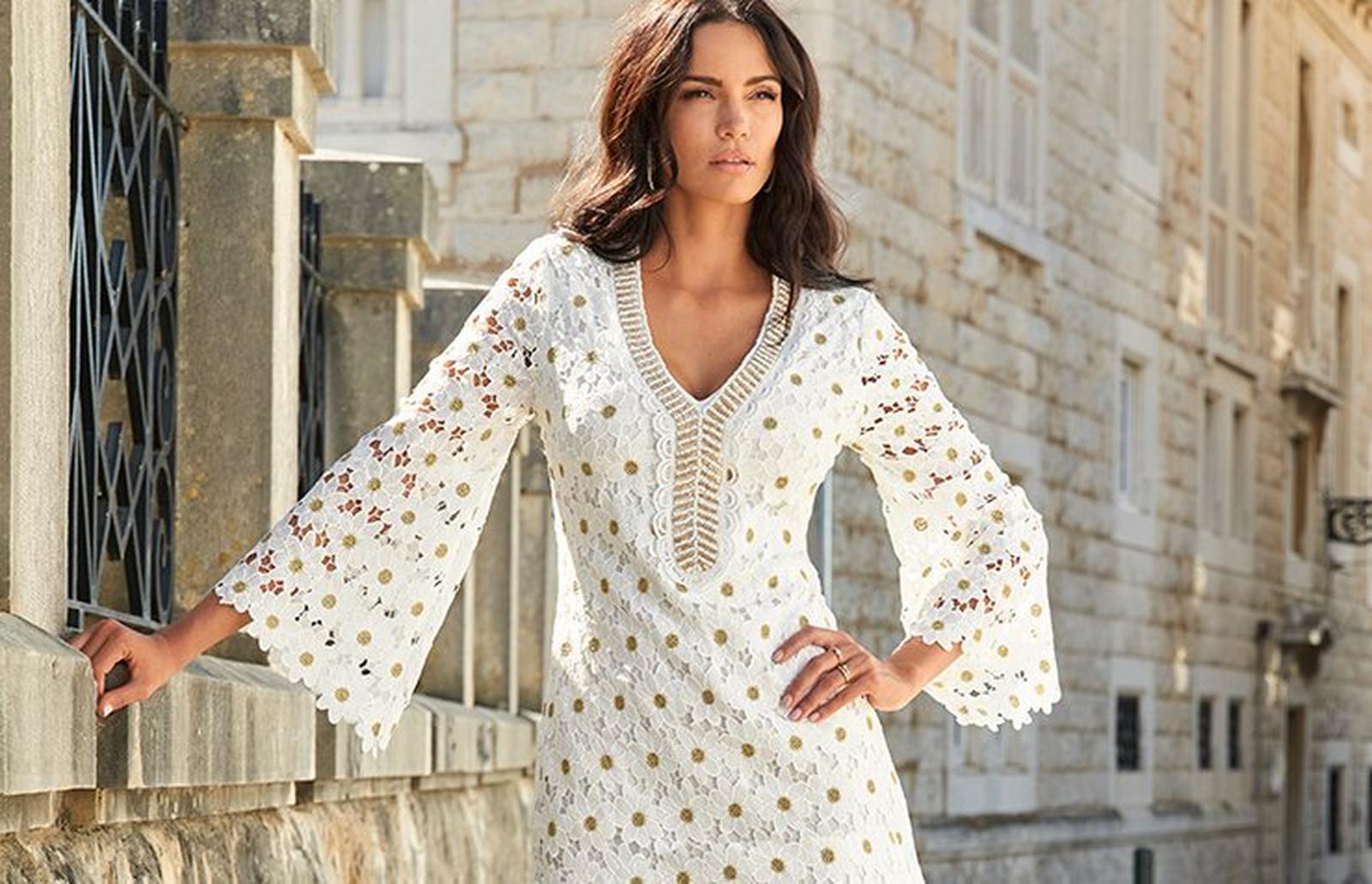 model wearing a white long-sleeve floral lace embellished shift dress.
