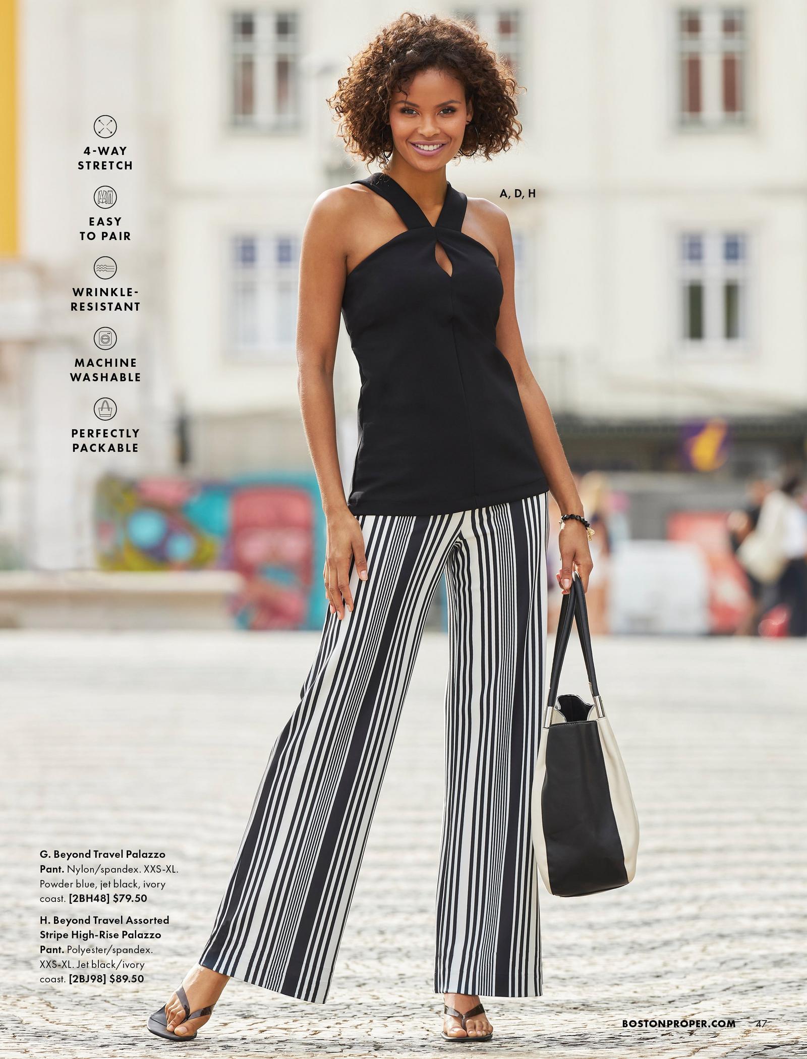 model wearing a black keyhole halter neck top, black and white striped palazzo pants, black thong heeled sandals, and holding a black and white bag.