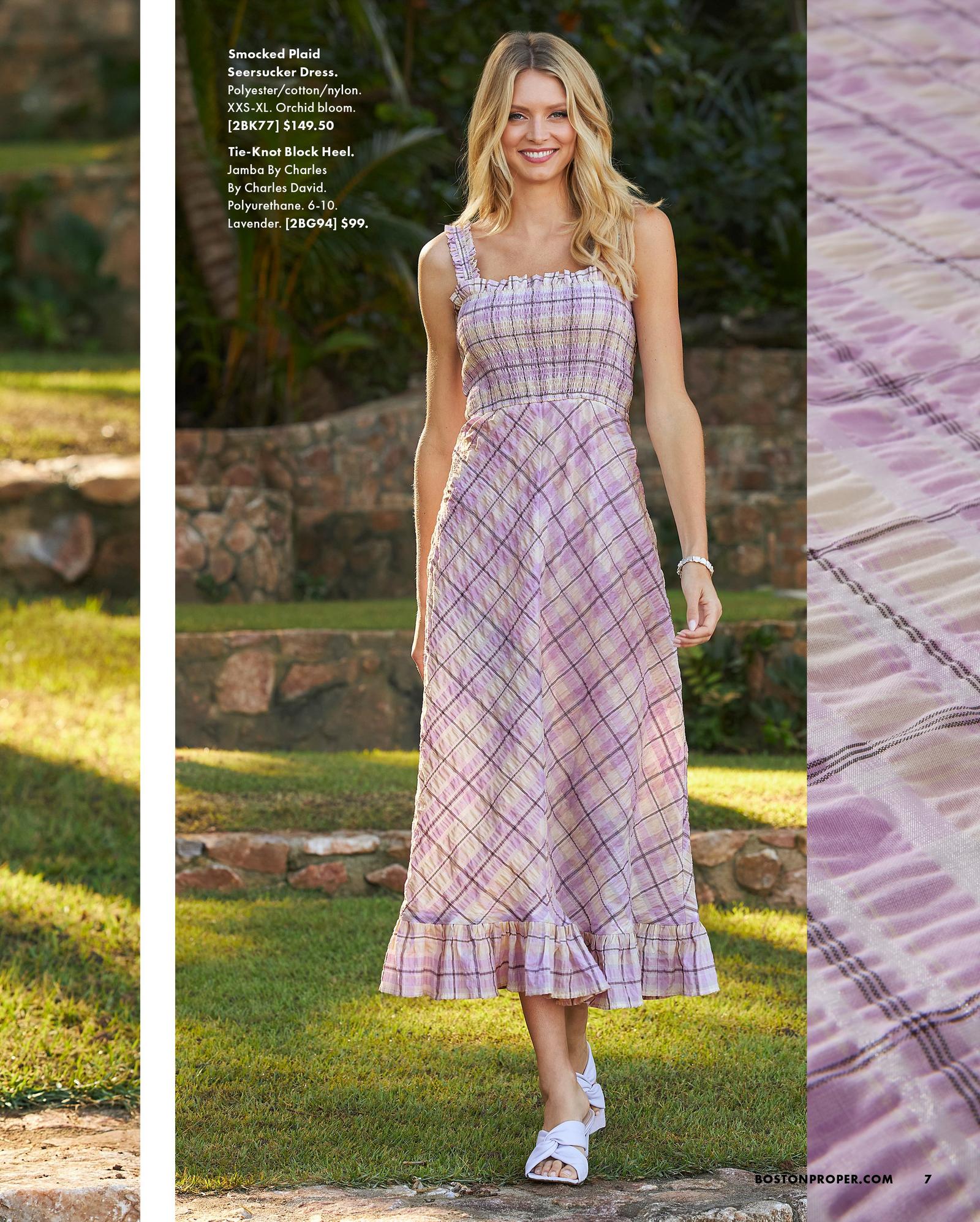 model wearing a lavender plaid smocked sleeveless seersucker dress and white block heels.