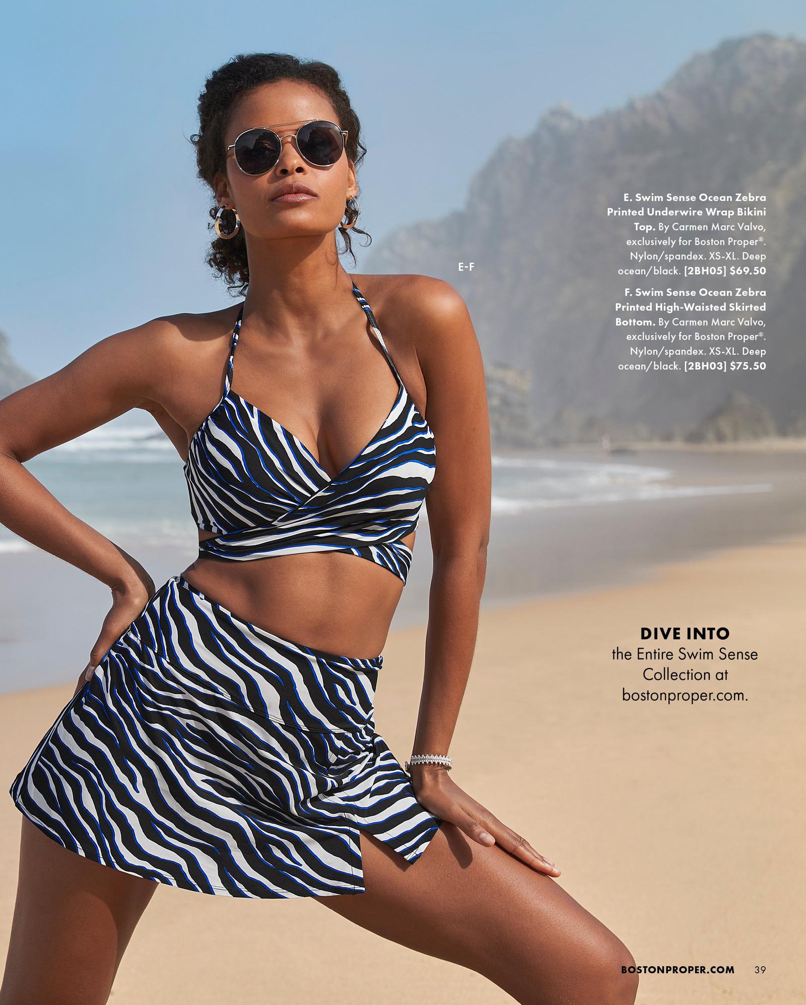 model wearing a blue and black zebra print bikini top and skirted bottom with sunglasses.