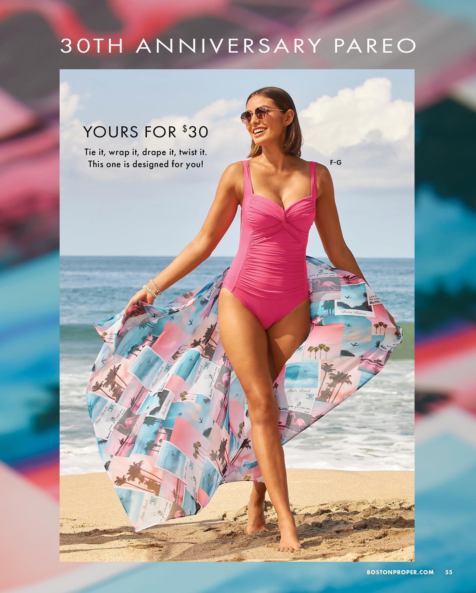 model wearing a pink one-piece swimsuit and postcard print pareo.