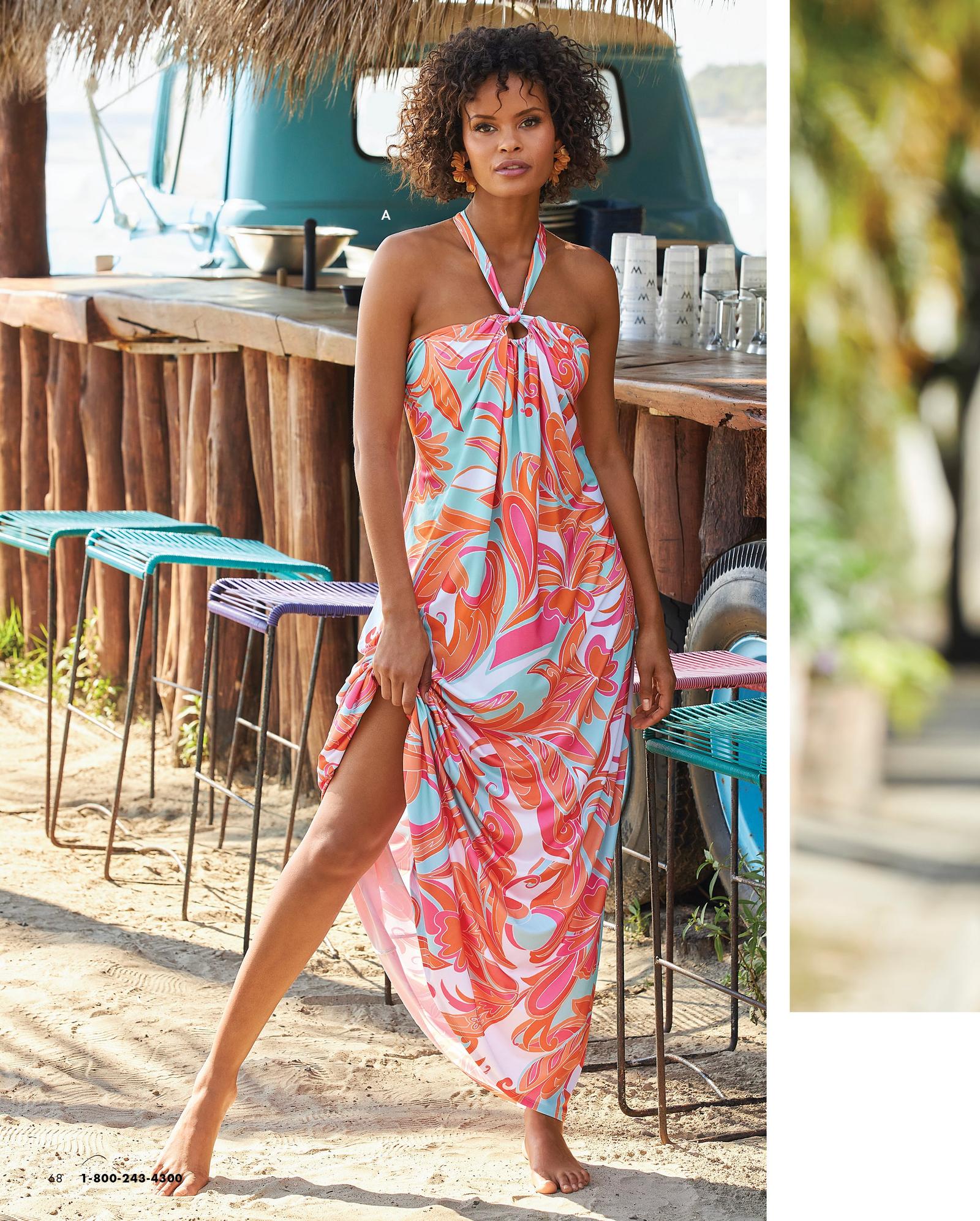 model wearing a printed multicolored halter-neck maxi dress.