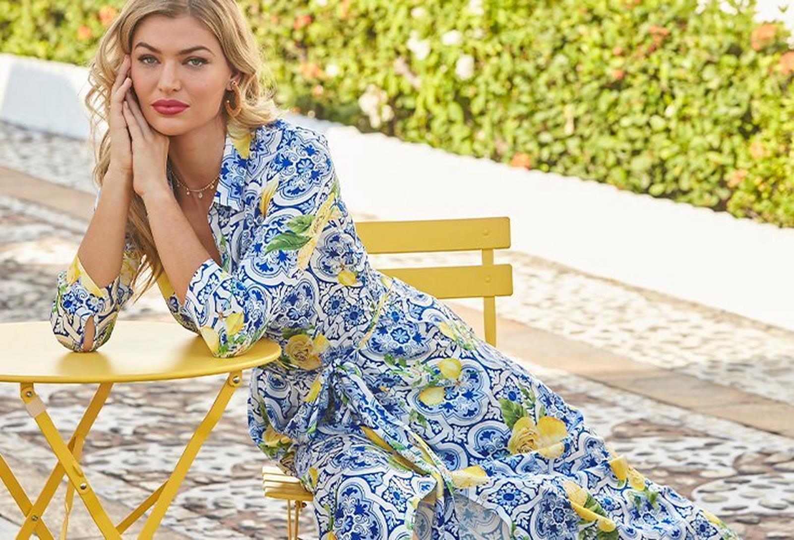 model wearing a flower and tile print long-sleeve wrap maxi dress.
