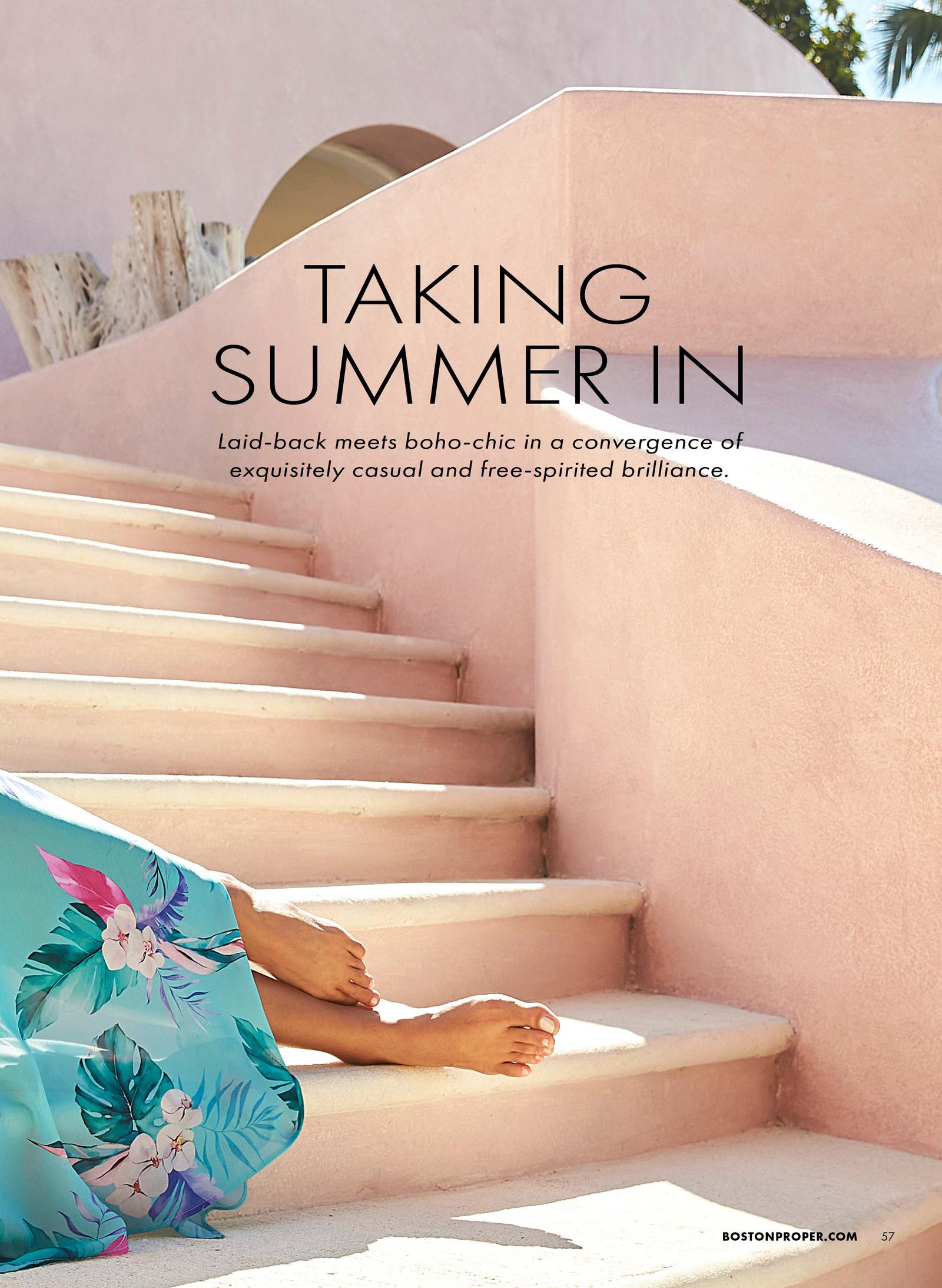 bottom half of a model wearing a floral print dress while lounging on a set of stairs.