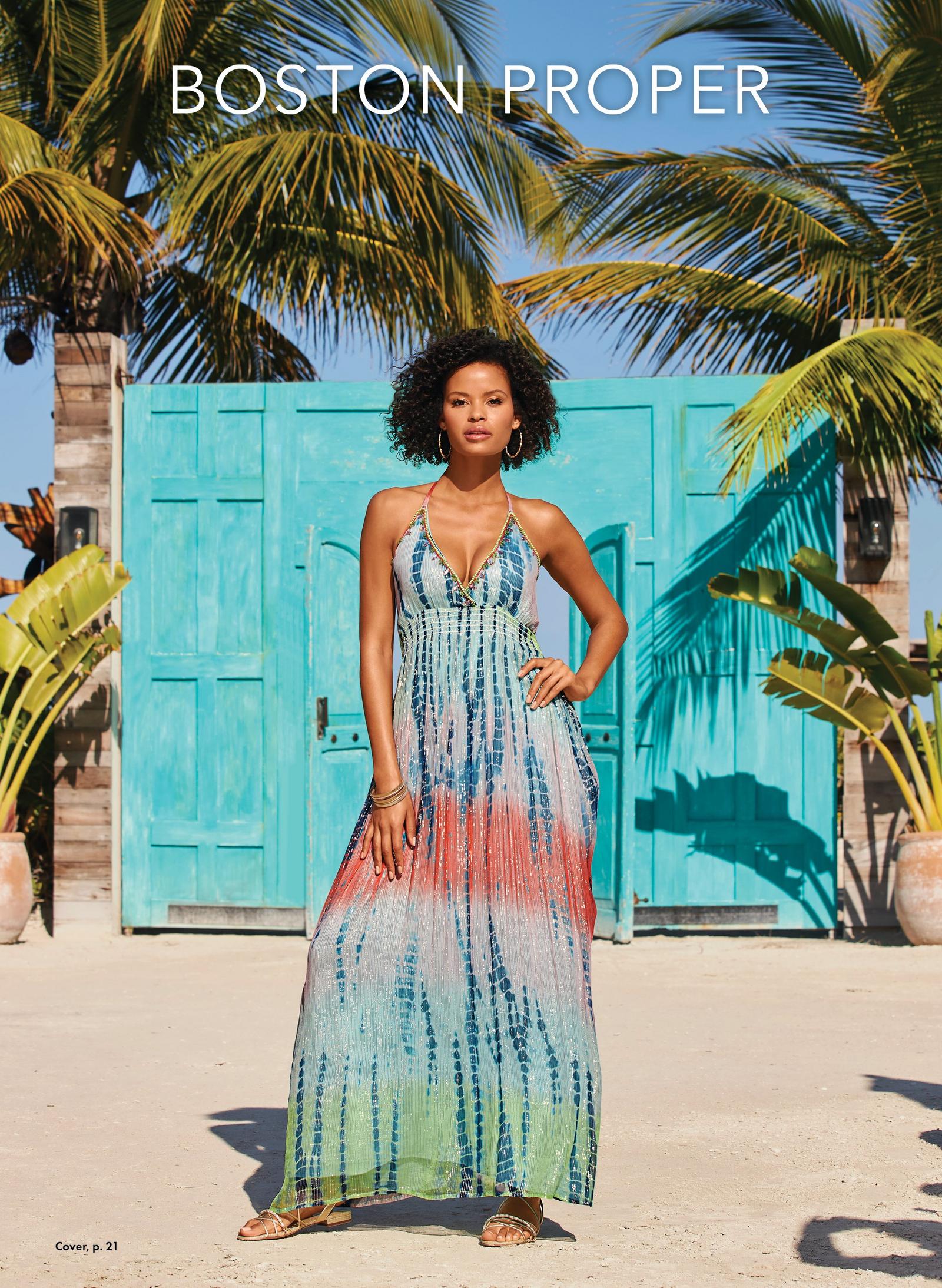 Model is wearing the Tie-Dye Print Embellished Maxi Dress in blues, white, coral and green with an embroidery trimmed bustline.