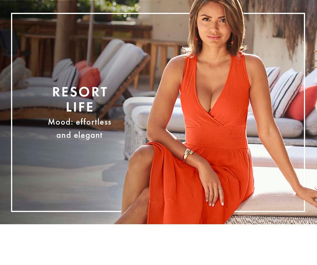 model wearing an orange v-neck sleeveless maxi dress.