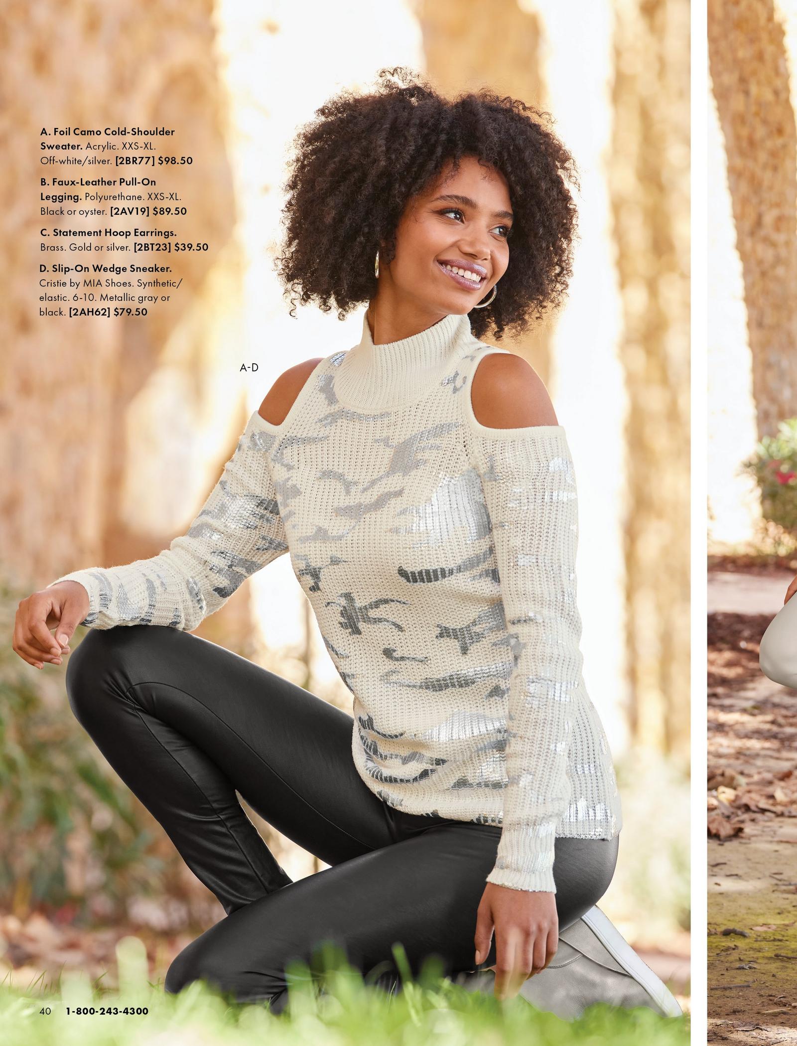 model wearing a white camo print foil embellished cold-shoulder turtleneck sweater, black faux leather leggings, silver hoop earrings, and gray metallic sneaker wedges.